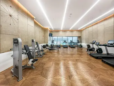 a gym with treadmills and exercise equipment in a room at NEW Luxury studio - Amazing Palm Views in Dubai