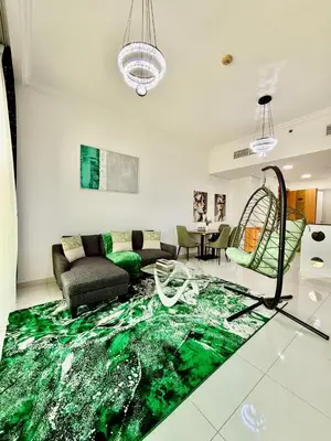 a living room with a green rug on the floor at Spacious Luxury Lagoon View 2Bhk in Dubai