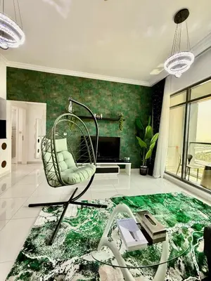 a room with a swinging chair and a piano at Spacious Luxury Lagoon View 2Bhk in Dubai