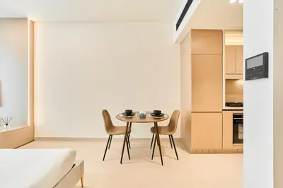 a kitchen and dining room with a table and chairs at Chic Studio in Dawn by Binghatti, Heart of JVC in Dubai