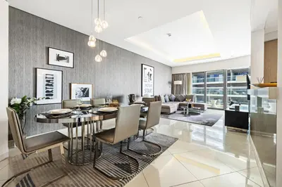 a dining room and living room with a table and chairs at BLVD - Luxury Stay with Burj Khalifa View in Dubai