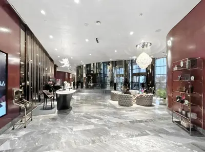 a lobby of a building with tables and chairs at BLVD - Luxury Stay with Burj Khalifa View in Dubai