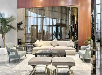 a lobby with a couch and chairs and a table at BLVD - Luxury Stay with Burj Khalifa View in Dubai