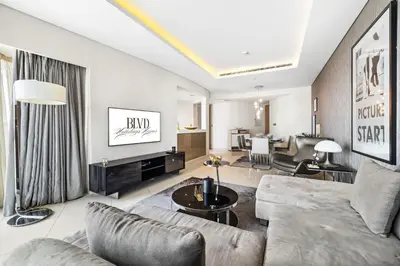 a living room with a couch and a table at BLVD - Luxury Stay with Burj Khalifa View in Dubai
