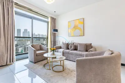 a living room with a couch and chairs and a table at Walking Distance to Circle Mall and Community Parks, 18 Minute Drive to Dubai Marina and JBR Beach, Crystal Residence, JVC by Deluxe Holiday Homes in Dubai