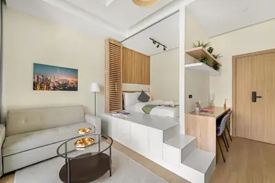 a room with a bed and a couch and a desk at Inviting Dubai Marina Studio near Beach and Canal in Dubai