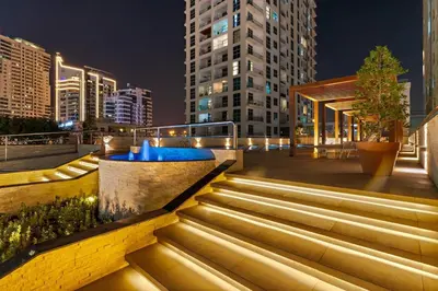 a set of stairs in a city at night at Inviting Dubai Marina Studio near Beach and Canal in Dubai