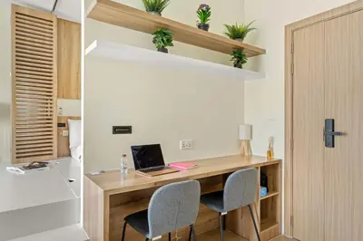 a room with a desk with two chairs and a laptop at Inviting Dubai Marina Studio near Beach and Canal in Dubai