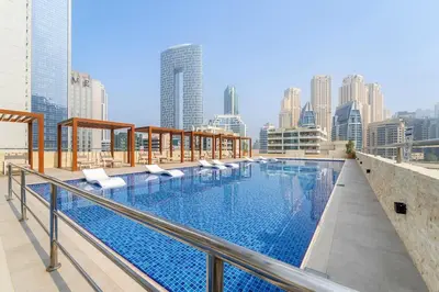 a swimming pool on top of a building with a city skyline at Inviting Dubai Marina Studio near Beach and Canal in Dubai