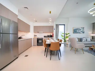 a kitchen and living room with a table and chairs at Stunning 2 bed dubai mall burj khalifa downtown ACT 1 in Dubai