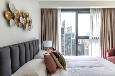 a bedroom with a bed with a large window at Stunning 2 bed dubai mall burj khalifa downtown ACT 1 in Dubai