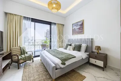 a bedroom with a bed and a desk and a window at Bloomfields Supreme Stu In Azizi Riviera in Dubai