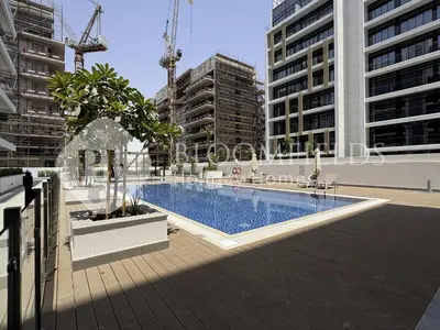 a swimming pool in a city with tall buildings at Bloomfields Supreme Stu In Azizi Riviera in Dubai