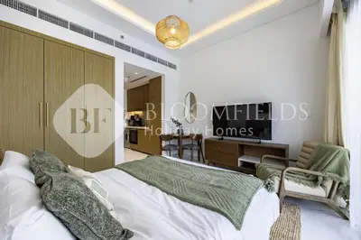 a bedroom with a bed and a sign on the wall at Bloomfields Supreme Stu In Azizi Riviera in Dubai