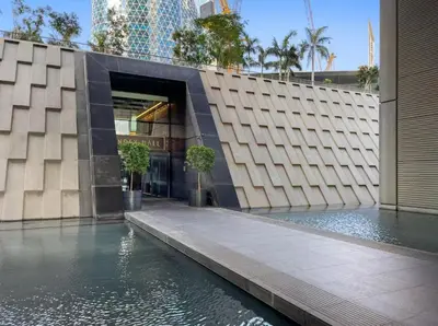 a building with a pool of water in front of it at DIFC Index Tower Burj Khalifa View 1BR in Dubai
