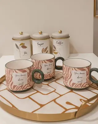 four coffee mugs on a tray on a counter at DIFC Index Tower Burj Khalifa View 1BR in Dubai