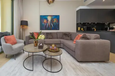 a living room with a couch and a table and chairs at Port de la Mer Luxury Sleeps 4Person in Dubai