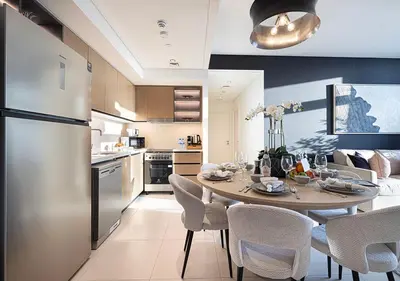 a kitchen and dining room with a table and chairs at Luxury Burj Crown Suites by Maison Aurora in Dubai