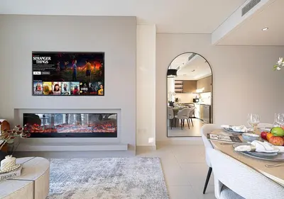 a living room with a fireplace and a dining room at Luxury Burj Crown Suites by Maison Aurora in Dubai