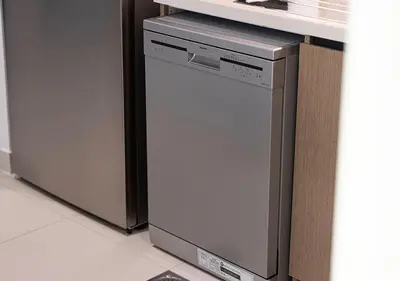 a dishwasher under a counter in a kitchen at Luxury Burj Crown Suites by Maison Aurora in Dubai