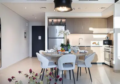 a kitchen with a table and chairs in a kitchen at Luxury Burj Crown Suites by Maison Aurora in Dubai