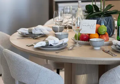 a table with fruit and wine glasses on it at Luxury Burj Crown Suites by Maison Aurora in Dubai