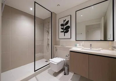 a bathroom with a shower and a toilet and a sink at Luxury Burj Crown Suites by Maison Aurora in Dubai
