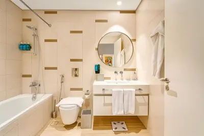 a bathroom with a tub and a toilet and a sink at Serene Ocean Views 2BR Emaar Beachfront in Dubai
