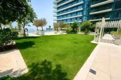 a large lawn in front of a building at Serene Ocean Views 2BR Emaar Beachfront in Dubai