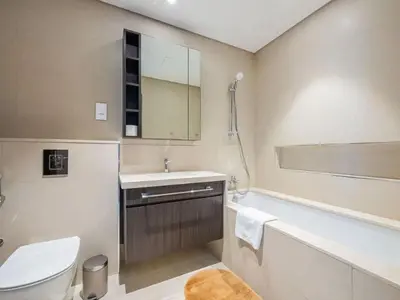 a bathroom with a toilet and a sink and a tub at Downtown views 1 Bedroom 5 PAX connect to Dubai mall in Dubai