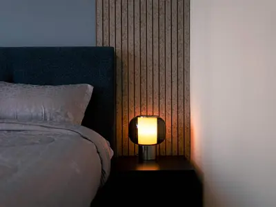 a lamp sitting on a table next to a bed at Continental Tower Luxury 2BR Dubai Marina Views in Dubai