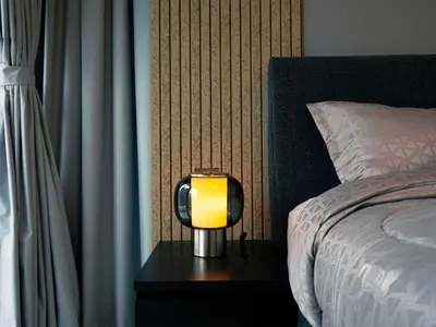 a lamp on a table next to a bed at Continental Tower Luxury 2BR Dubai Marina Views in Dubai