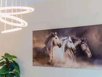 a painting of three horses hanging on a wall at Continental Tower Luxury 2BR Dubai Marina Views in Dubai