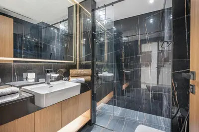 a bathroom with a sink and a shower at Serene and Stylish Home in the Heart of JVC in Dubai