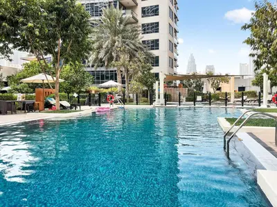 a large pool with blue water in front of a building at Stunning 2 Bdr Luxury Burj Khalifa view in Dubai