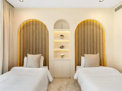 two beds sitting next to each other in a room at Dubai Hills Mansion Cinema, Gym & Luxe Pool in Dubai