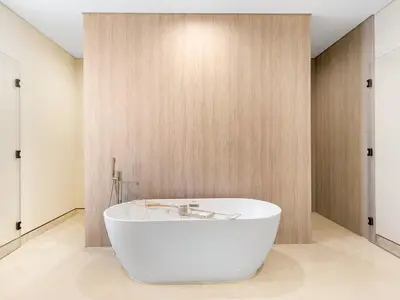 a white bath tub in a bathroom with wooden walls at Dubai Hills Mansion Cinema, Gym & Luxe Pool in Dubai