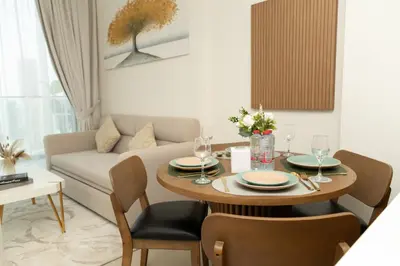 a living room with a table and a couch at Binghatti Amber in JVC, 15 Min to Marina in Dubai