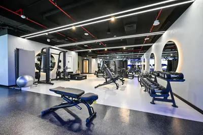 a gym with treadmills and machines in a room at Modern 1BR w Balcony & Great Amenities JVC in Dubai