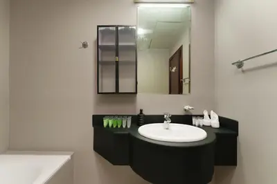 a bathroom with a sink and a mirror at Large Flat in High Floor with view to Marina Canal & Beach sleep 8px in Dubai