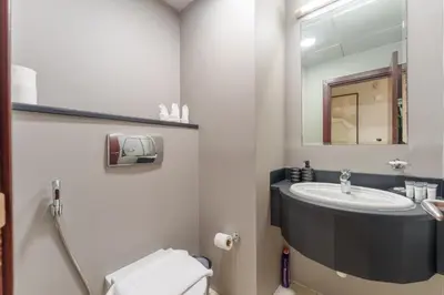 a bathroom with a sink and a mirror at Large Flat in High Floor with view to Marina Canal & Beach sleep 8px in Dubai