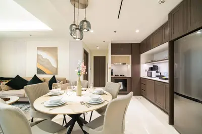 a dining room and living room with a table and chairs at SettlerHomes - 14F Ocean View Gem With Private Beach in Dubai