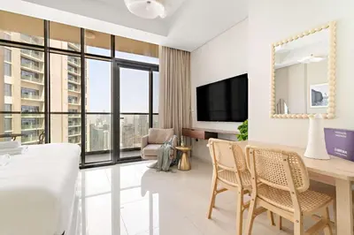 a living room with a table and chairs and a television at Silkhaus Studio Escape in Business Bay in Dubai