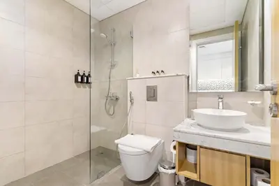 a bathroom with a shower and a toilet and a sink at Silkhaus Studio Escape in Business Bay in Dubai