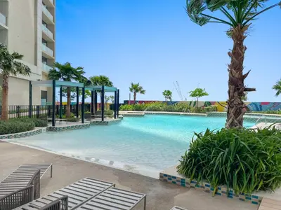 a large swimming pool with a gazebo and palm trees at Silkhaus Studio Escape in Business Bay in Dubai