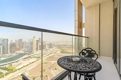 a table on a balcony with a view of a city at Silkhaus Studio Escape in Business Bay in Dubai