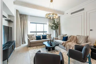 a living room with a couch and a table at Spacious 2 bedroom apartment I Palm Jumeirah in Dubai