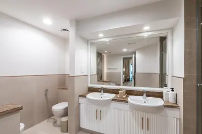 a bathroom with two sinks and a mirror at Spacious 2 bedroom apartment I Palm Jumeirah in Dubai