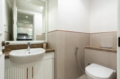 a bathroom with a sink and a toilet and a mirror at Spacious 2 bedroom apartment I Palm Jumeirah in Dubai