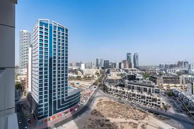 an aerial view of a city with tall buildings at White Sage Modern Studio in JVC with Balcony and City Views in Dubai